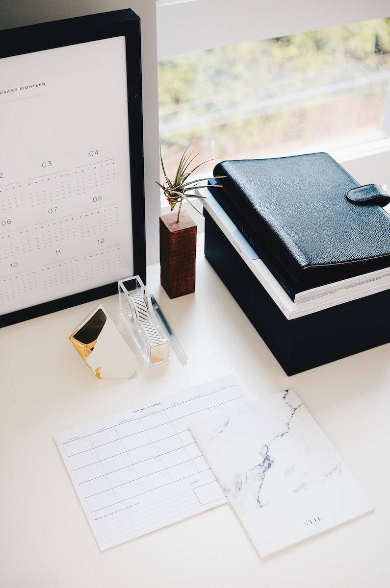Books and calendar on a white table